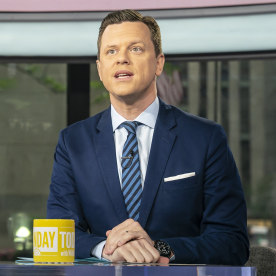 Willie Geist sitting at the desk with a yellow Sunday TODAY mug