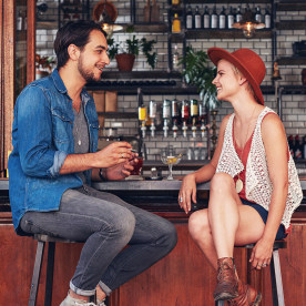 Young couple sitting at cafe counter