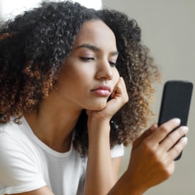 Woman looking at mobile phone screen
