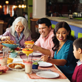Family enjoying dinner in mexican restaurant