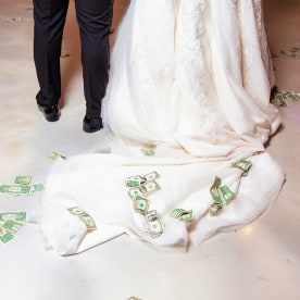 Bride and groom first dance with money on floor