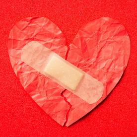 crumpled heart with a bandaid on it