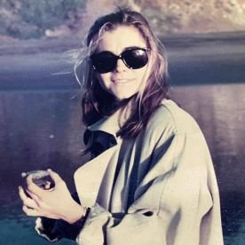 Old photo of Ruth outside by a lake 