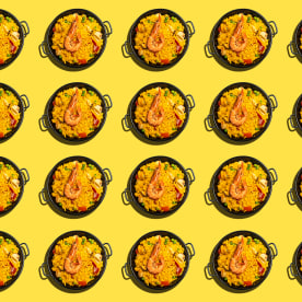 Repeated dishes of paella on yellow background.