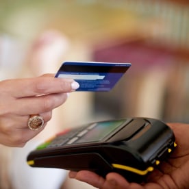 Woman paying with a credit card on a mobile POS system.