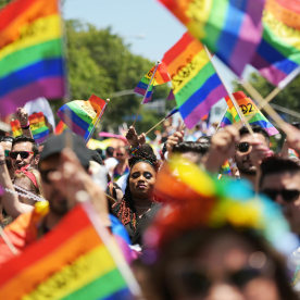 People wave rainbow flags and participate in the annual LA Pride Parade 