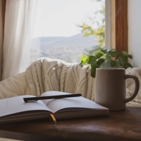 Cozy Window Nook with Open Journal And Coffee