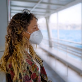 Woman with protective face mask on the ferry