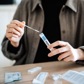 Woman carrying out a Covid-19 test at home.