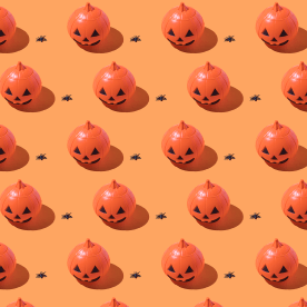 Pattern of plastic Halloween Jack-O-Lantern pumpkins.