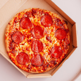 Pizza with pepperoni in box.