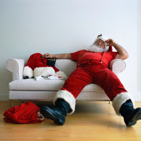 Exhausted Santa Claus on Couch