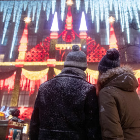 A couple covered in snow watches the Holiday lights at Saks Fifth Avenue during a snow storm  on December 16, 2020 in New York City. 