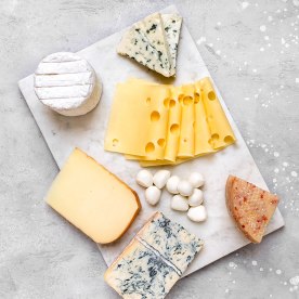 Italian and French gourmet Cheese platter with craft cheese assortment mozzarella hard cheeses, mold cheese, gorgonzola, pecorino, Emmental, Roquefort