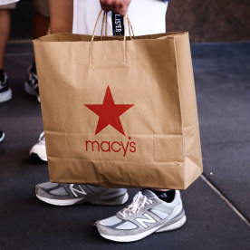 A man is holding Macy's paper bag in Manhattan, New York, United States of America, on July 5th, 2024.