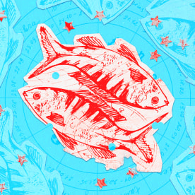 Paper cutouts of the Pisces zodiac on a blue background