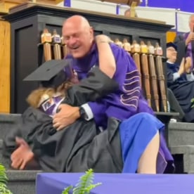 Clemson University president gets (lovingly) knocked to the ground by his daughter during graduation
