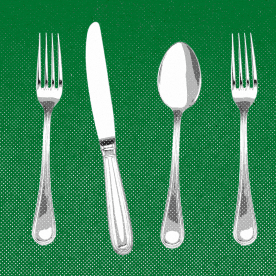 Forks, knives, and spoons lined up against a green background.