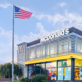 McDonald's Building Exterior with US Flag in Front.