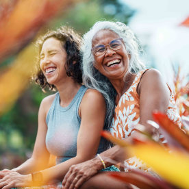 Pacific Islander woman and Eurasian adult daughter spending time together outdoors