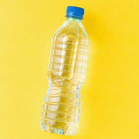Overhead shot of water bottle on a yellow background.