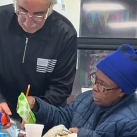 Hazaa Alabdullah serves food to his classmates at CRIS Ohio.