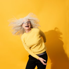 Portrait of mature woman dancing, smiling and having fun