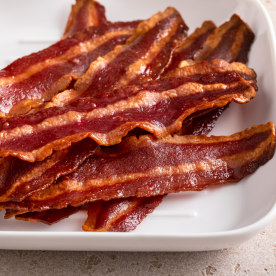 Turkey bacon cooked on a white plate iron pan