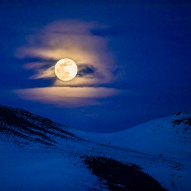 Full moon over mountains at night in Bellevue, Idaho, USA