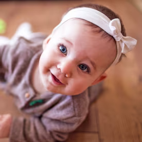 Cute Baby Girl Crawling In Living Room