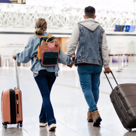 Couple at the airport walking to board