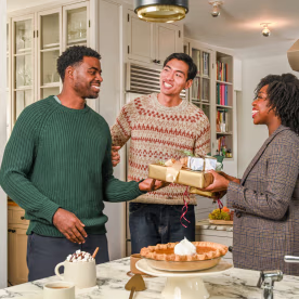 three people exchanging gifts with their brother in law