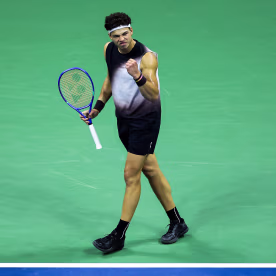 Ben Shelton of the United States celebrates on the tennis court.