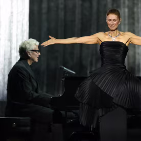 Canadian singer Celine Dion reacts as she performs during her first concert of a series at the Plenitude Arena.