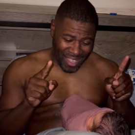 Dad Robert Haney, who is deaf, signs to his newborn daughter.