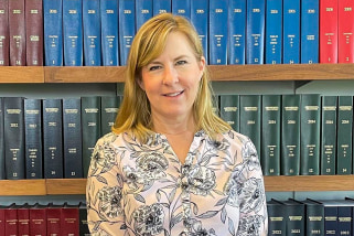 Minnesota House Speaker Melissa Hortman stands in front of Minnesota law books in her office in St. Paul in 2023.