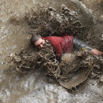 A runner takes part in the Mud Day, a 13km obstacle race on Oct. 1, 2016 in Merignac, southwestern France. (Photo by Nicolas Tucat/AFP/Getty)