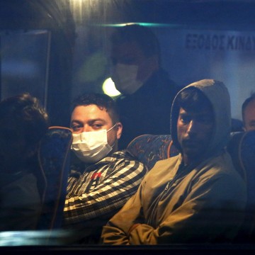 Image: Migrants on a bus before boarding a Turkish-flagged passenger boat to be returned to Turkey, on the Greek island of Lesbos