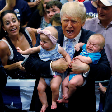 Image: Republican presidential nominee Donald Trump holds babies at a campaign rally in Colorado Springs,