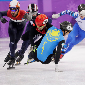 Hongzhi Xu of China and Nurbergen Zhumagaziyev of Kazakhstan collide and crash out during the men's 1,500 meter short track speed skating heat on Feb. 10.