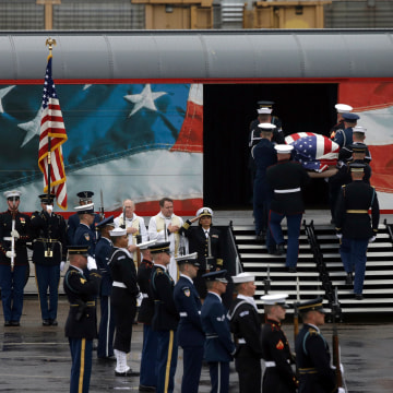 Image: A joint services military honor guard brings former President George H.W. Bush's casket onto a Union Pacific train.