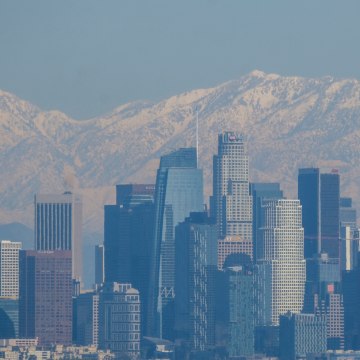 After a rare snowstorm in Southern California, snow covered the San Gabriel mountain range are seen behind downtown Los Angeles skyline.