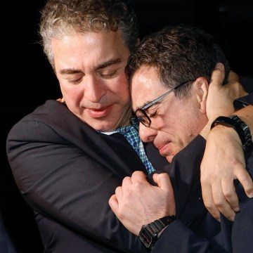 American Siamak Namazi is embraced by his brother after arriving at an airfield in Virginia on Tuesday. Namazi was one of five Americans freed from prison in Iran this week in a swap that included the unfreezing of $6 billion of Iranian funds. The Iranian