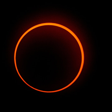 A stunning sight in the sky across the Western Hemisphere on Saturday of the annual solar eclipse known as the \"ring of fire.\" The orange glow of the sun can be seen peeking out in a perfect circle from the behind the Moon. The spectacular eclipse dar