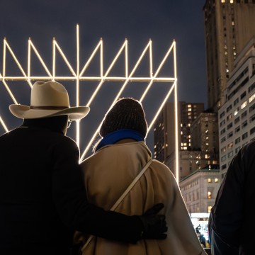 A gathering in Manhattan around the \"World's Largest Menorah\" on Thursday's first night of Hanukkah. The menorah is more than 30-feet tall and weighs some four thousand pounds. The holiday taking-on special significance this year given the war in Israel,