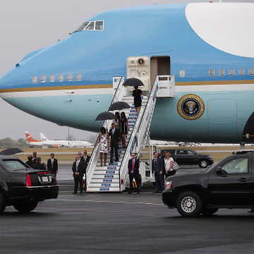 Image: President Barack Obama and Michelle Obama followed by their daughters, Malia and Sasha walk down the stairs