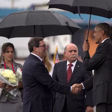 Image: President Barack Obama, right, shakes hands with Cuba's Foreign Minister Bruno Rodriguez as first lady Michelle Obama stands behind