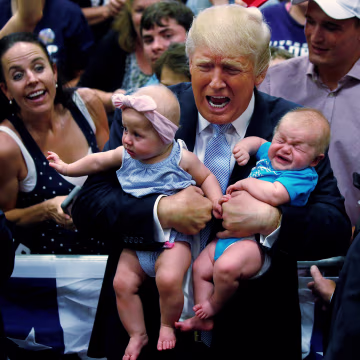 Image: Republican presidential nominee Donald Trump holds babies at a campaign rally in Colorado Springs,