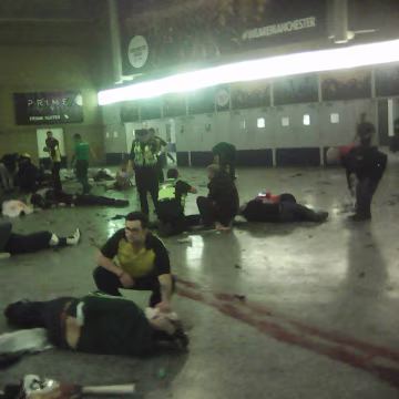 Image: Helpers attend to people inside the Manchester Arena after a suspected suicide bomber detonated an explosive device