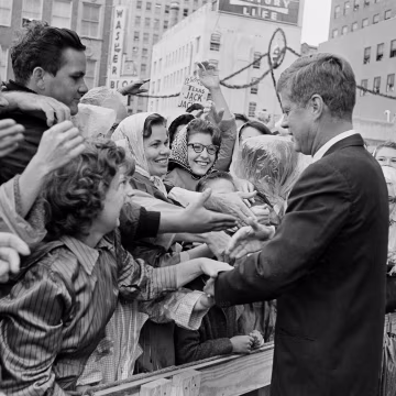 Image: President John F. Kennedy is greeted by an enthusiastic crowd in front of the Hotel Texas